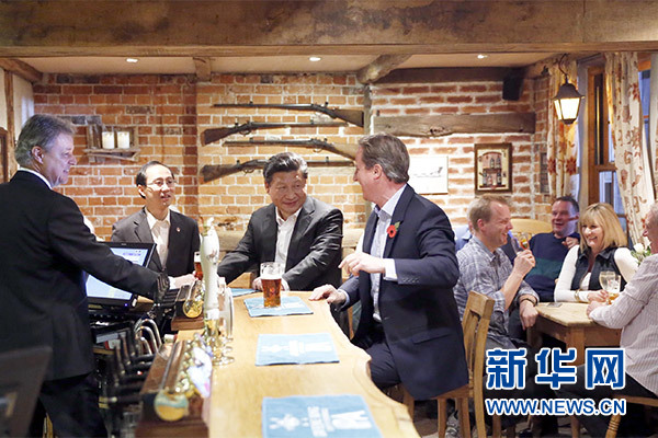 這是會晤結束后,習近平在卡梅倫陪同下乘車前往當地小鎮體驗酒吧文化。新華社記者 鞠鵬 攝 這是會晤結束后,習近平在卡梅倫陪同下乘車前往當地小鎮體驗酒吧文化。新華社記者 鞠鵬 攝